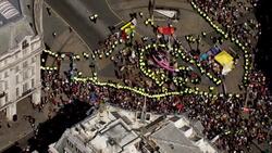 Aerials of police surrounding the pink Extinction Rebellion yacht News Clip