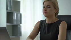 Beautiful office worker feeling terrible headache, working on computer, health Stock Footage