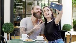 Young couple taking a selfie in the coffee shop Stock Footage
