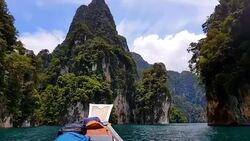 Moving follow boat with Beautiful mountains lake river sky and natural attractions in Ratchaprapha Dam at Khao Sok National Park, Surat Thani Province, Thailand. Stock Footage