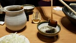 Motion of woman pouring sauce on sesame at Japanese restaurant Stock Footage