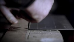 A sheet of steel is scored by a blacksmith in a workshop. Stock Footage