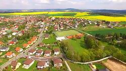 Camera flight over small village Litice suburb of Pilsen. Living in agricultural landscape. Environmentally friendly living. Czech Republic, Europe. Stock Footage
