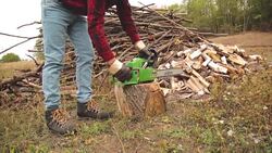 Lumberjack fixing / maintain the chainsaw outdoors. Stock Footage