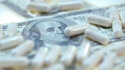 Pharmaceutical business. White medical capsules on dollar banknote Stock Footage