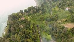 Train quickly moving on Batumi railway along seacoast, transport infrastructure Stock Footage