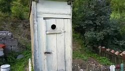 Aerial of Wooden Outhouse Orbit Stock Footage