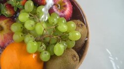 Slow motion washing mix fruit in wooden bowl. Stock Footage
