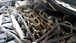 Mechanic fixing cylinder head with camshaft of car engine Stock Footage