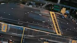 Aerial top down view over expressway toll gate with many vehicles passing through and pay fee. Stock Footage