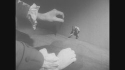 1950s: Hands touch steel rod to copper wire holding frog's legs Stock Footage