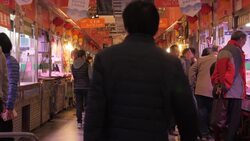 Butchers serving customers at a Beijing meat market News Clip