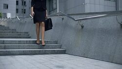 Lady in business suit walking downstairs from office center, end of working day Stock Footage