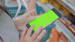 Young women using smartphone in supermarket,Green screen Stock Footage