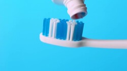 Toothbrush and toothpaste, dental healthcare and oral hygiene, macro shot Stock Footage