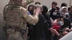 Military try to direct people attempting to escape the country into line News Clip