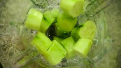 Crushing of cucumbers in the blender. Slow motion.	Preparation of smoothie in the blender. Top view. Stock Footage