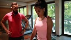 Athletic woman doing deadlift in front of her personal trainer Stock Footage