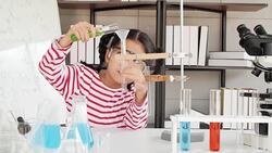 Education Topics:Funny little girl doing experiments in the laboratory.Science and education. Stock Footage