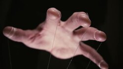 Closeup of a puppet hand with string tied around the fingers Stock Footage