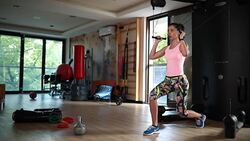 Strong and fit woman pulling hard on a pulling machine Stock Footage