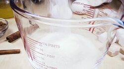 Slow motion glass measuring cup on the table near the ingredients Stock Footage