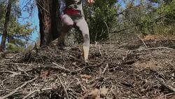 slow motion fit woman running down a hill of dirt and branches Stock Footage