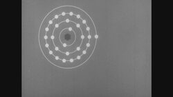 1950s: Illustrated copper atom and electron with text Stock Footage