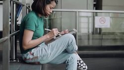 Designer drawing a sketch on tablet using stylus at city Stock Footage