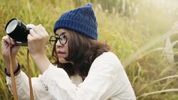 Asian tourist woman taking pictures of the mountainside with her camera at Stock Footage