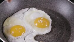 Salting fried eggs Stock Footage