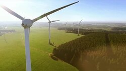Wind turbines and agricultural fields on a summer day Stock Footage
