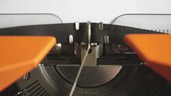 Close up footage of a person writing TERRORISM on an old typewriter, with sound Stock Footage