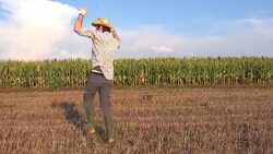 Happy satisfied farmer is dancing in corn field Stock Footage