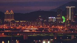 4k shot of busy Taipei City, the capital of Taiwan on a romantic evening in blue twilight with a Ferris wheel in Dazhi Commercial District Stock Footage