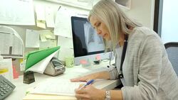 Female doctor reviewing medical chart in doctors office Stock Footage