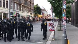 Riot police running towards protesters News Clip