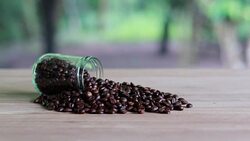 Close up of coffee beans shooting over wooden background. Stock Footage
