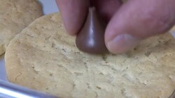 Decorating a sugar cookie with a chocolate drop Stock Footage