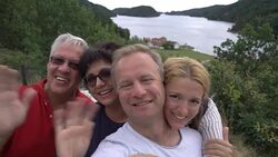 A big happy family takes a selfie or Uses Phone Video Call Camera on the seacoast. Stock Footage