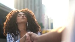 Young playful hipster couple holding hands at city sunset Stock Footage
