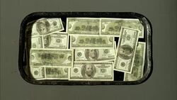 CLOSE ANGLE OF US ONE HUNDRED DOLLAR BILLS WITH BEN FRANKLIN'S IMAGE VISIBLE. 100 DOLLAR BILLS SEEM TAPED OR STUCK ONTO WINDOW OF DOOR. AMERICAN CURRENCY. Stock Footage