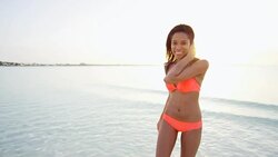 Portrait of ethnic girl taking selfie on beach Stock Footage