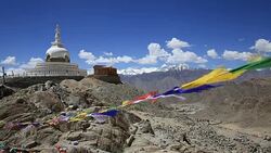 Colorful Buddhist prayer flags at temple in the Shanti Stupa. Leh, Ladakh, India Stock Footage