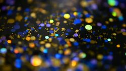 Defocused shimmering multicolored glitter confetti, black background. Party, magic, imagination. Rainbow colors, sparkle circles. Holiday abstract festive texture of shiny blurred bokeh light spots. Stock Footage