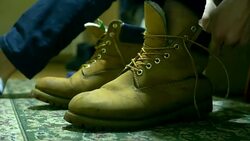 close up person ties warm winter classic shoelaces of boots Stock Footage