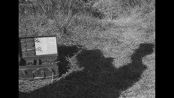During Korean War, US Marine getting haircut outdoors somewhere in South Korea News Clip