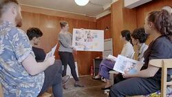 Female creative designer leading meeting, discussing photograph proofs in office Stock Footage