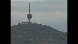 Smoke rising from behing a telecommunications tower on hill News Clip