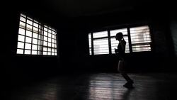 silhouette young purposeful female boxer in wrapped bandage hands jumping on skipping rope Stock Footage